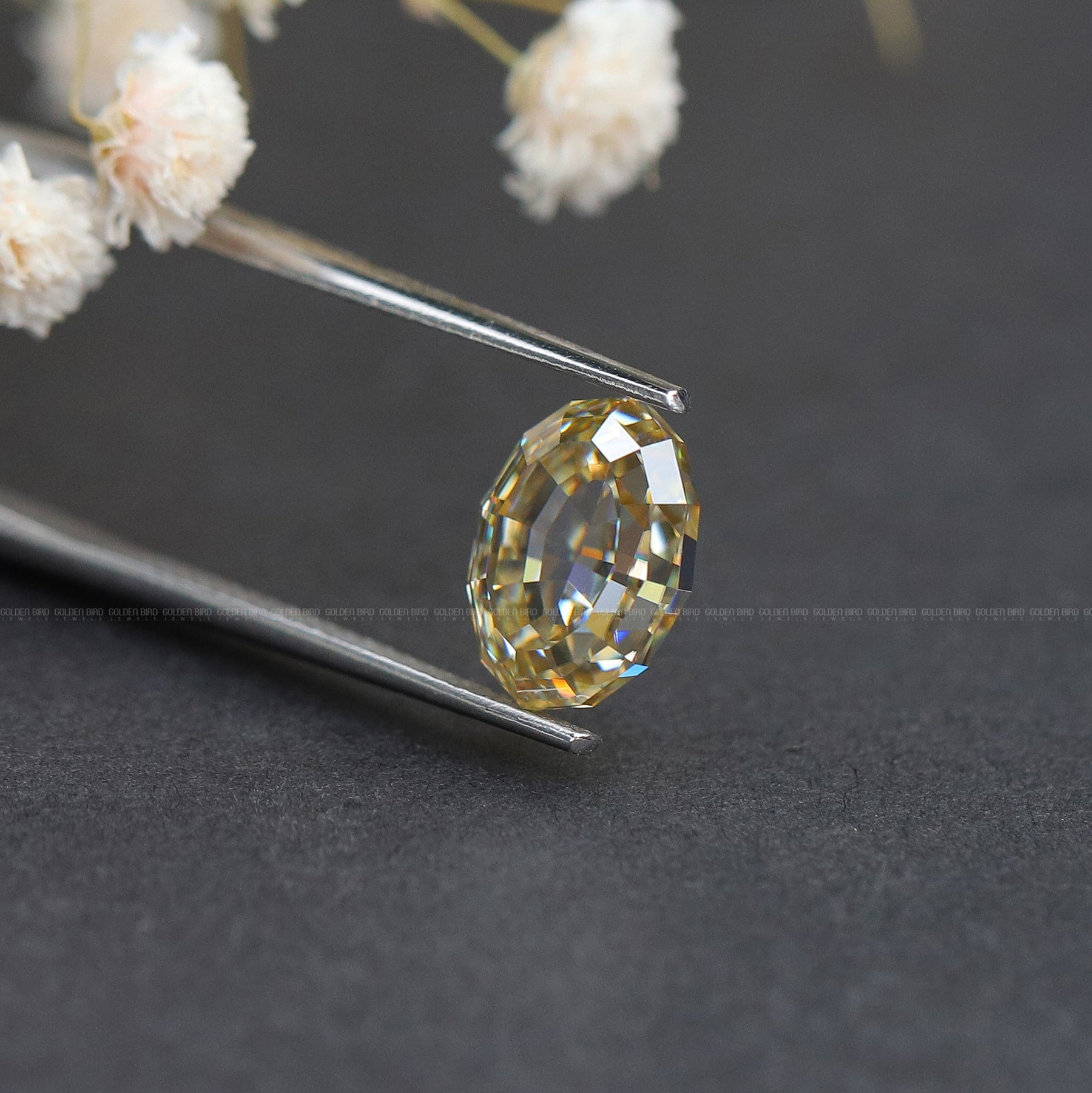 In Tweezer View Of Yellow Oval Cut Loose Stone