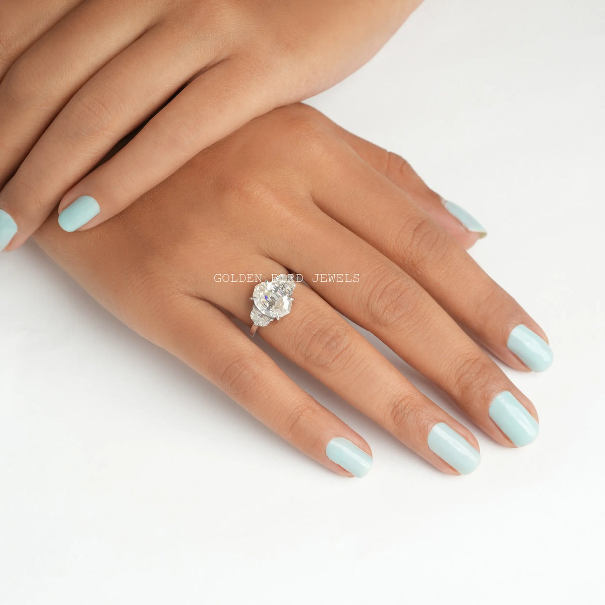 Finger view of an oval-shaped solitaire moissanite engagement ring