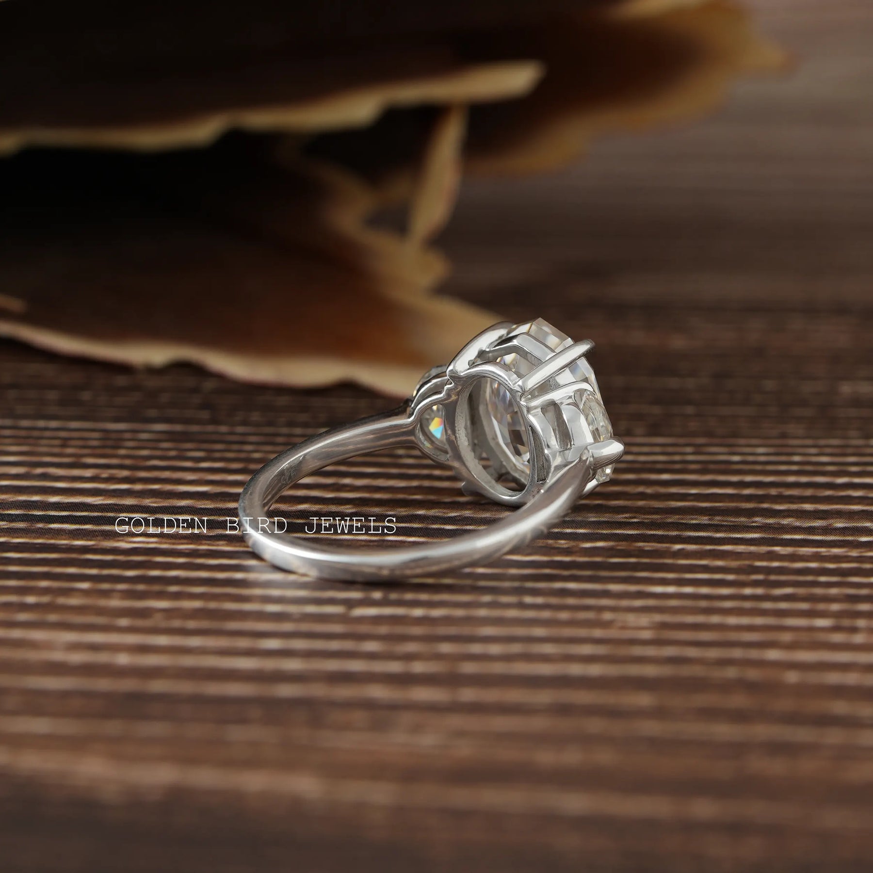 Back view of a three-stone moissanite engagement ring in white gold