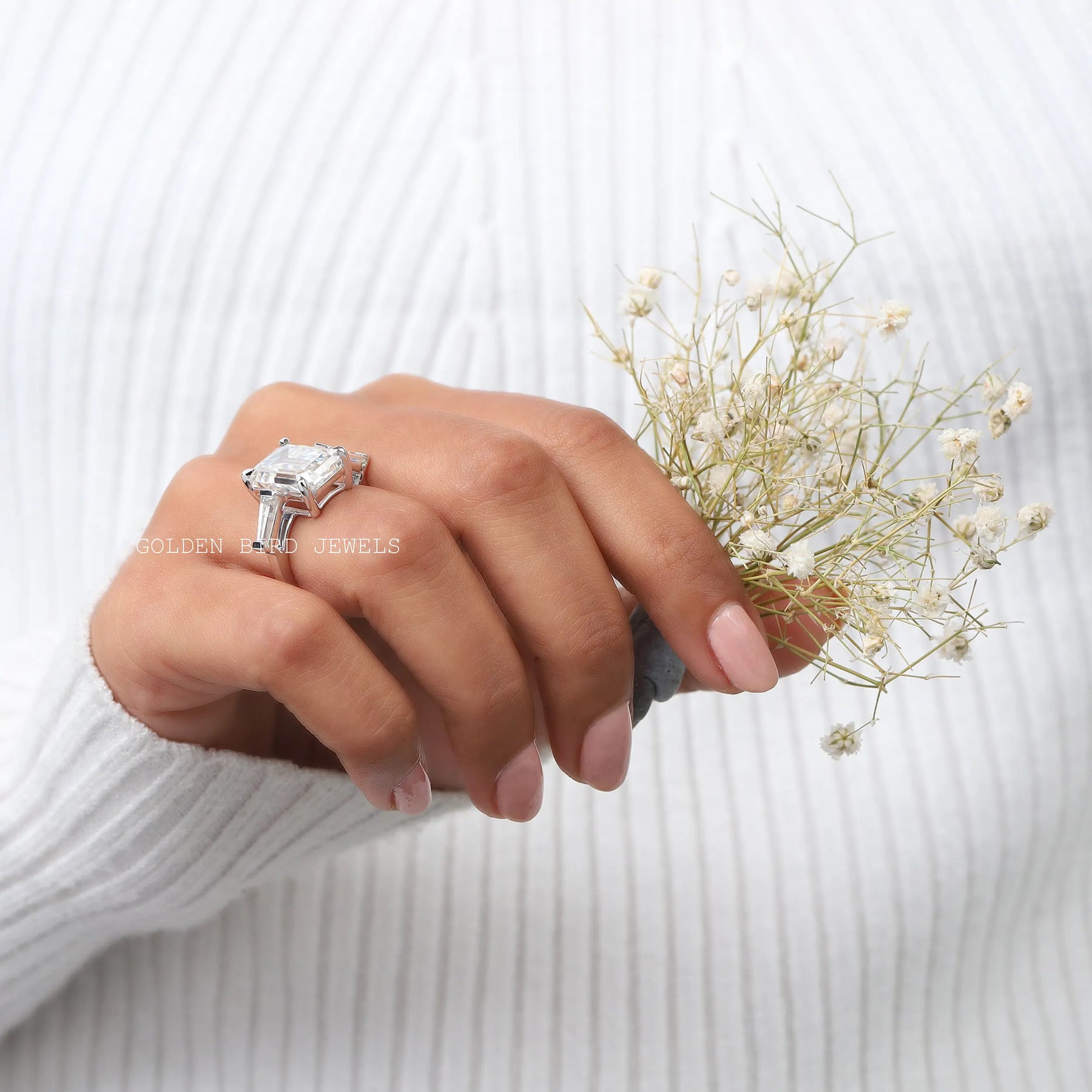 Three Stone Emerald Cut Moissanite Ring With Tapper Baguette Cut Side Stones In Finger