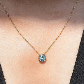 View of round cut moissanite solitaire pendant 