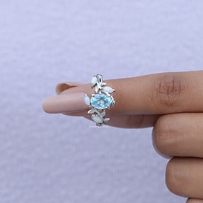 In finger front View of Oval Cut Gemstone Leaf Style Accent Ring