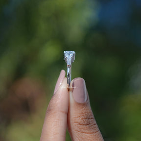 Side View of Asscher And Tapered Baguette Cut Five Stone Ring In two fingers