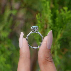 Back view of Fancy Green Elongated cushion moissanite hidden halo ring in secure setting 
