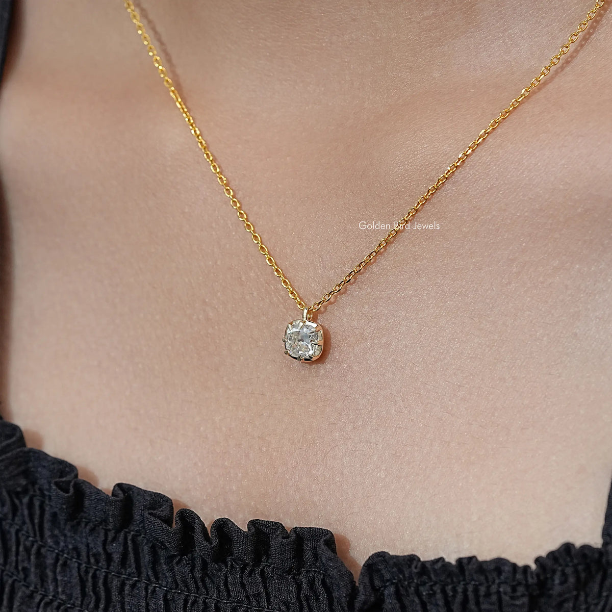 Gold tone pendant necklace with round moissanite solitaire on fine chain