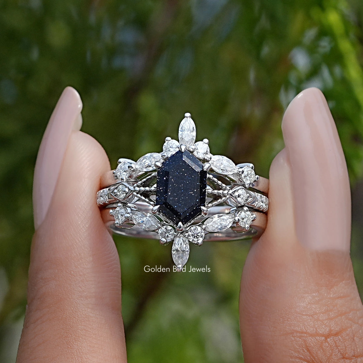 Sterling silver bridal ring with dark blue hexagon center and white stone halo