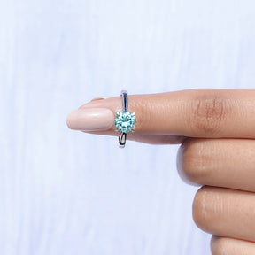 In finger front view of  Blue Green Round moissanite Solitaire Ring  in unique shape