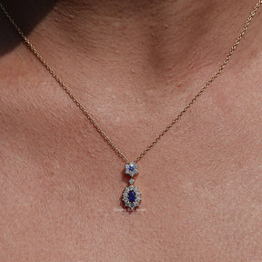 Front view of Blue Sapphire Oval Gemstone Halo Pendant In Women's 