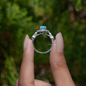 Back View of Pear Cut Gemstone Accent Ring In two fingers