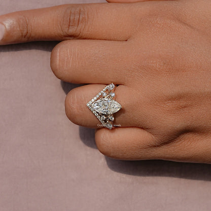 Gold-tone marquise cut cluster ring close-up with prong-set center and side stones