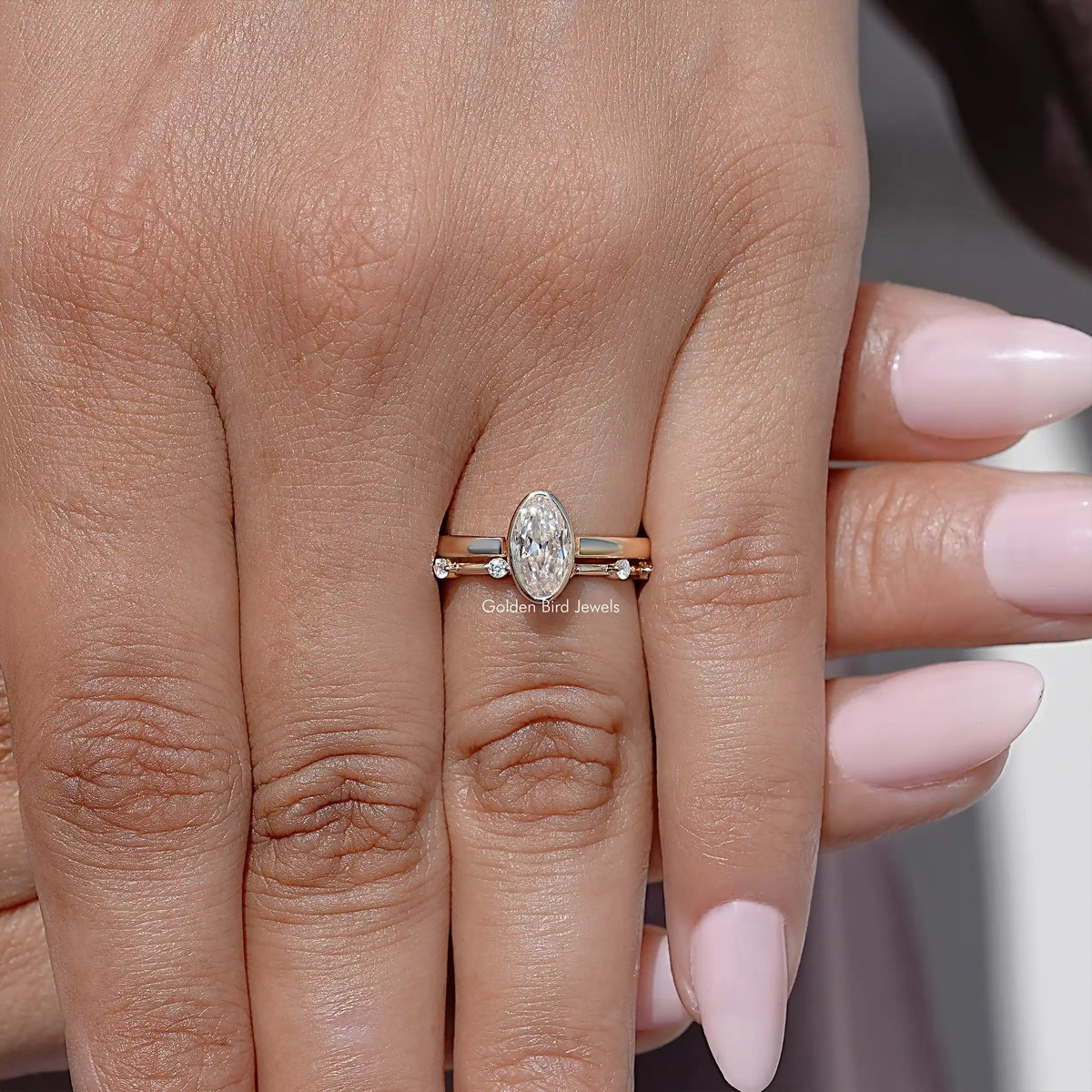 Gold-toned oval moissanite solitaire ring set with slim stacked bands