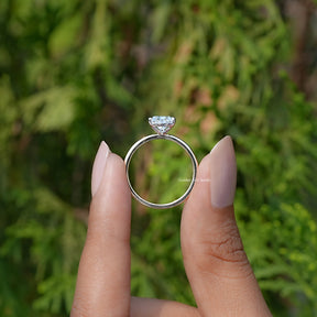 Back View of Pear Cut Lab Diamond Solitaire Engagement Ring In two fingers