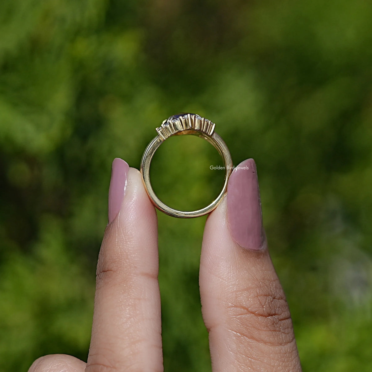 Gold-tone ring band with prongs and small clear stones along top edge