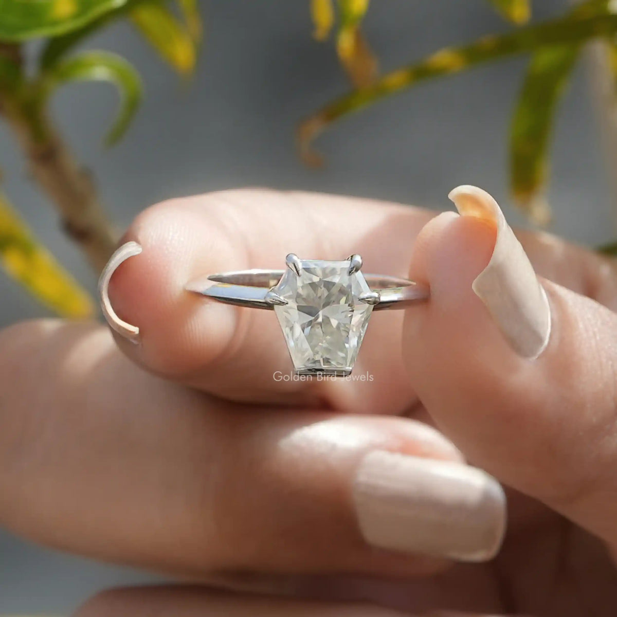Front view of Calf's Head Cut Moissanite Solitaire Ring in two fingers