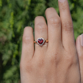 In finger front view of Red Ruby Heart engagement ring 
