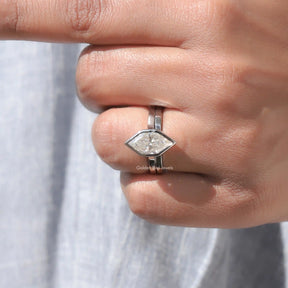 Finger view of moissanite  engagement ring in secure setting 