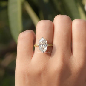 Close-Up View of Oval Cut Moissanite Prong Set Ring In Yellow Gold        