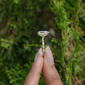 Side View of Oval Cut Moissanite Twist Shank Ring In two fingers
