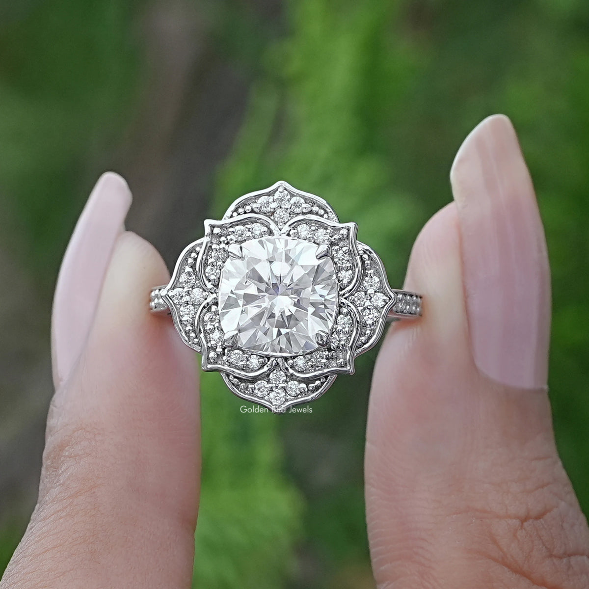 Two fingers holding the Cushion Cut Moissanite Halo Wedding Ring