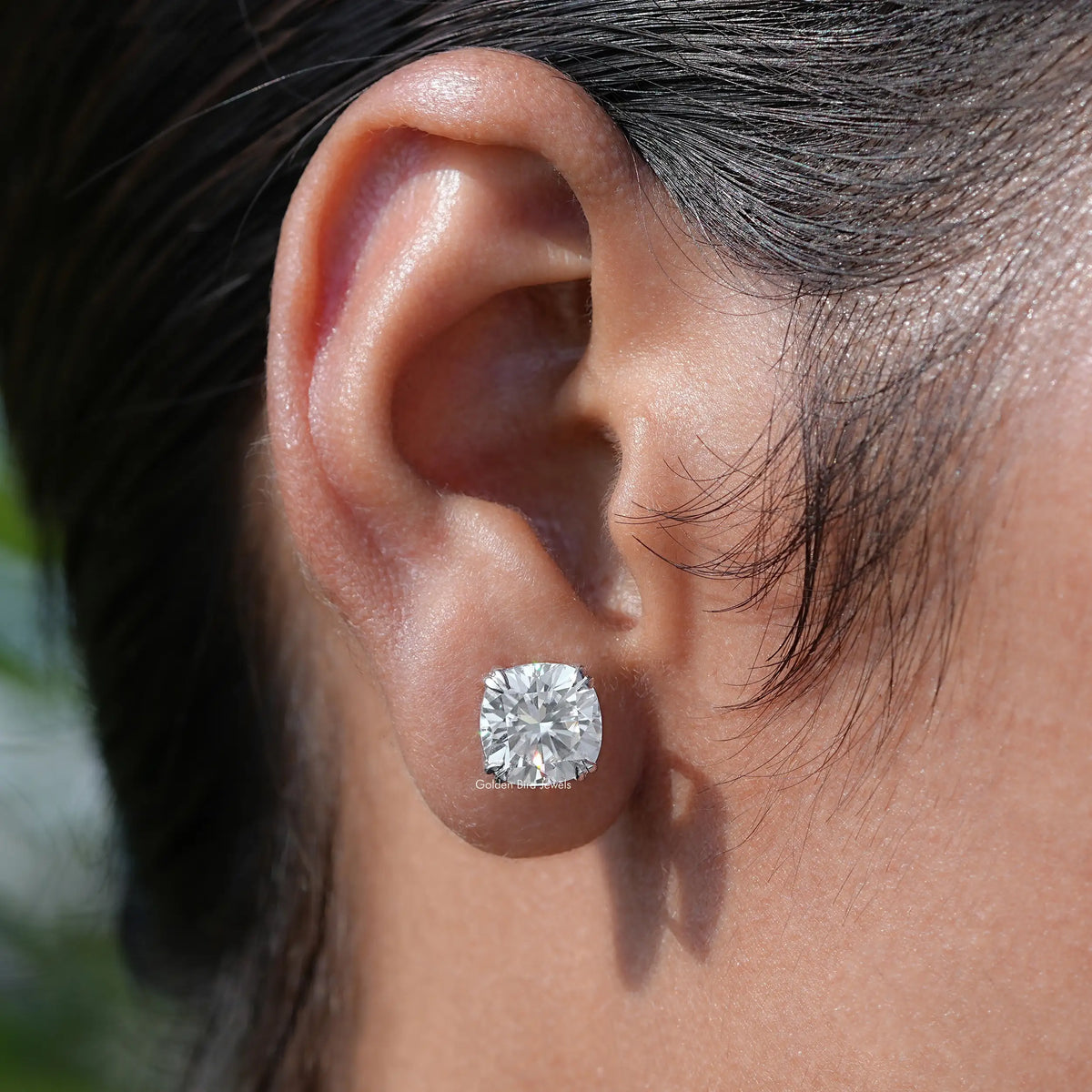 In ear view of moissanite emerald Cut Stud Earrings 