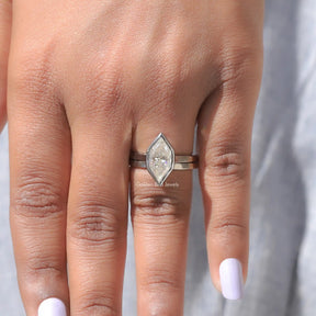 in finger view of marquise cut moissanite  gold ring 