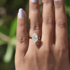 Close-up of 14k Yellow Gold Dutch Marquise Moissanite Ring on finger