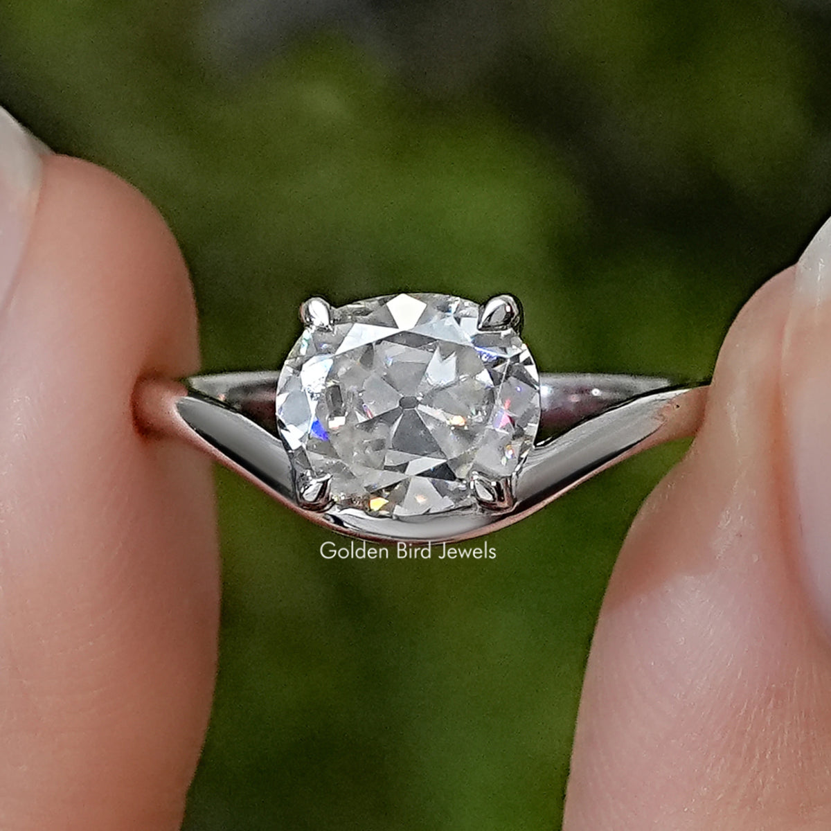 Sterling silver solitaire ring with a large oval-cut moissanite and curved band