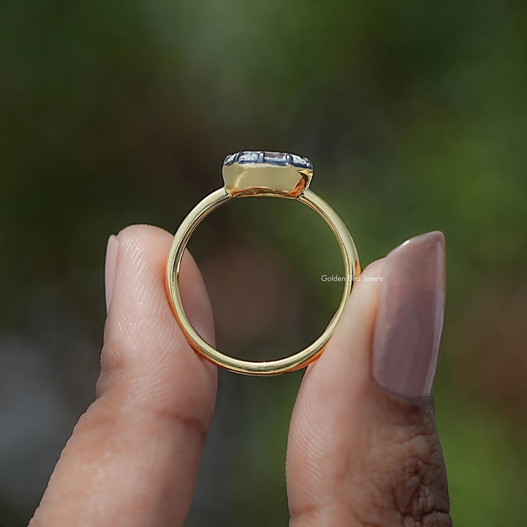Back view of East West Oval Cut Moissanite Solitaire Ring in secure setting 