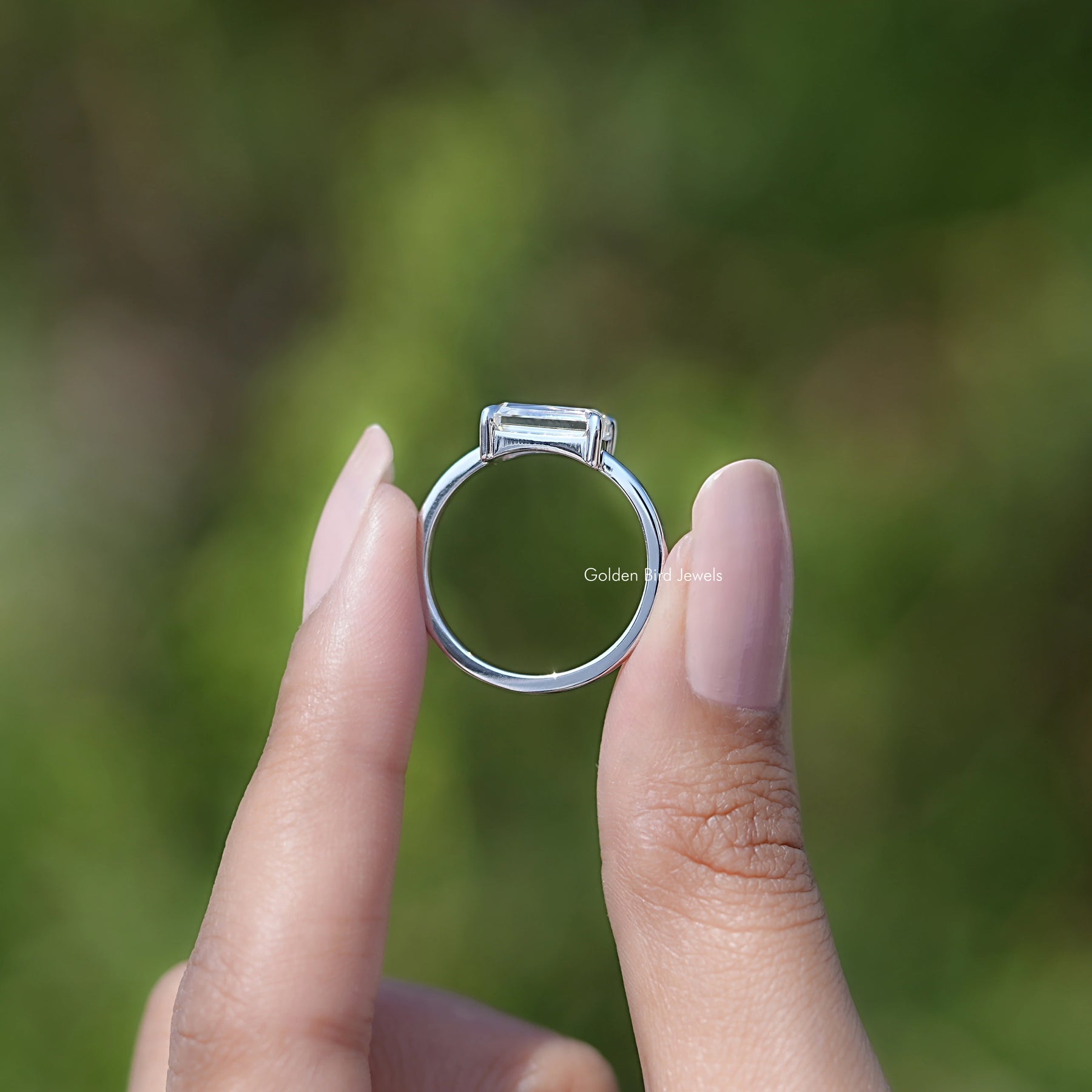 Back view of East West Portrait Radiant Moissanite Solitaire Ring in secure setting