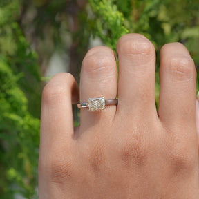 In finger front view of East West Yellow Radiant moissanite Solitaire Ring 
