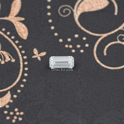 Loose emerald-cut moissanite gemstone, clear rectangular step-cut stone.
