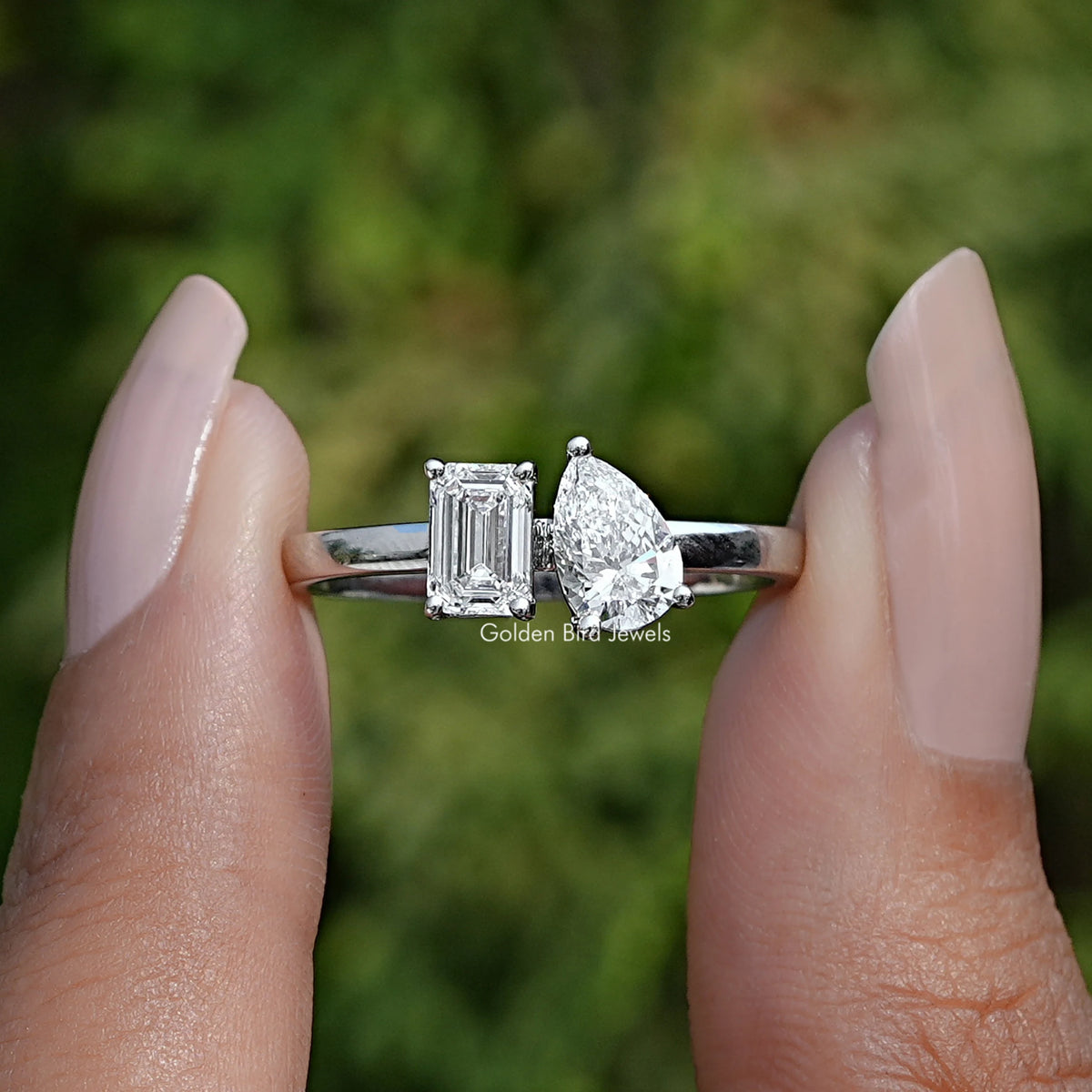 Front View of Emerald And Pear Cut Lab Diamond Toi Et Moi Ring In two Fingers