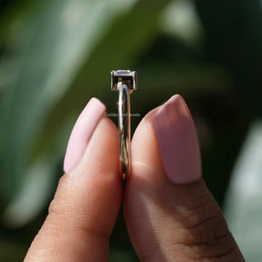 Side View of Trillion Cut Moissanite Toi Et Moi Ring In two fingers