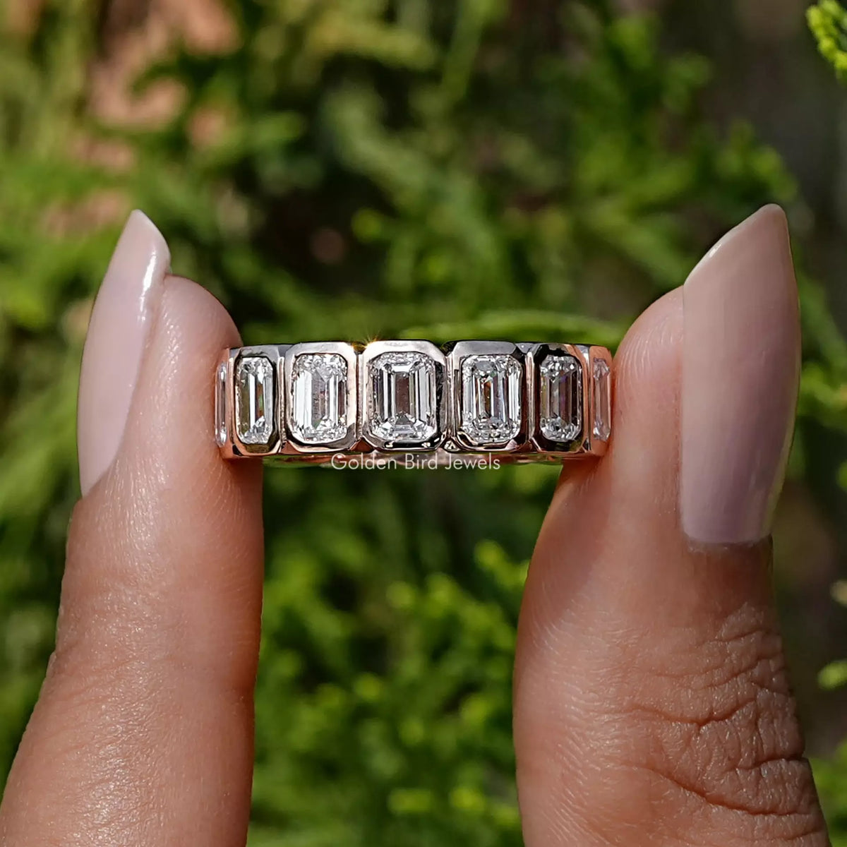 Front View of Emerald Cut Diamond Bezel Set Eternity Band In two Fingers