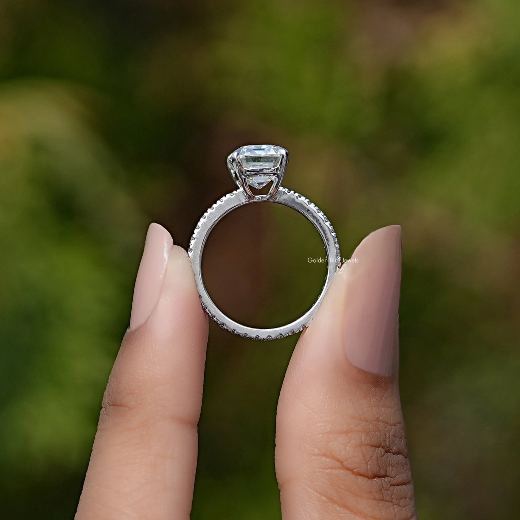 Back view of Emerald Cut Moissanite Solitaire Ring in secure setting 