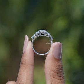 Back View of Emerald And Baguette Cut 5 Stone Diamond Ring In two fingers