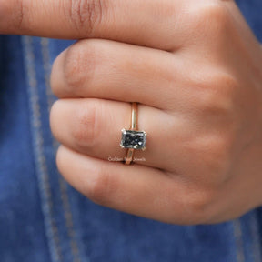 In finger front view of Moissanite Engagement Ring in Step Cut Oval Moissanite in unique shape