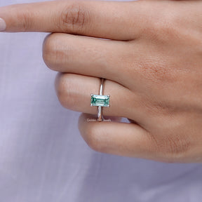 View of solitaire Green Emerald Cut Ring in prongs setting 