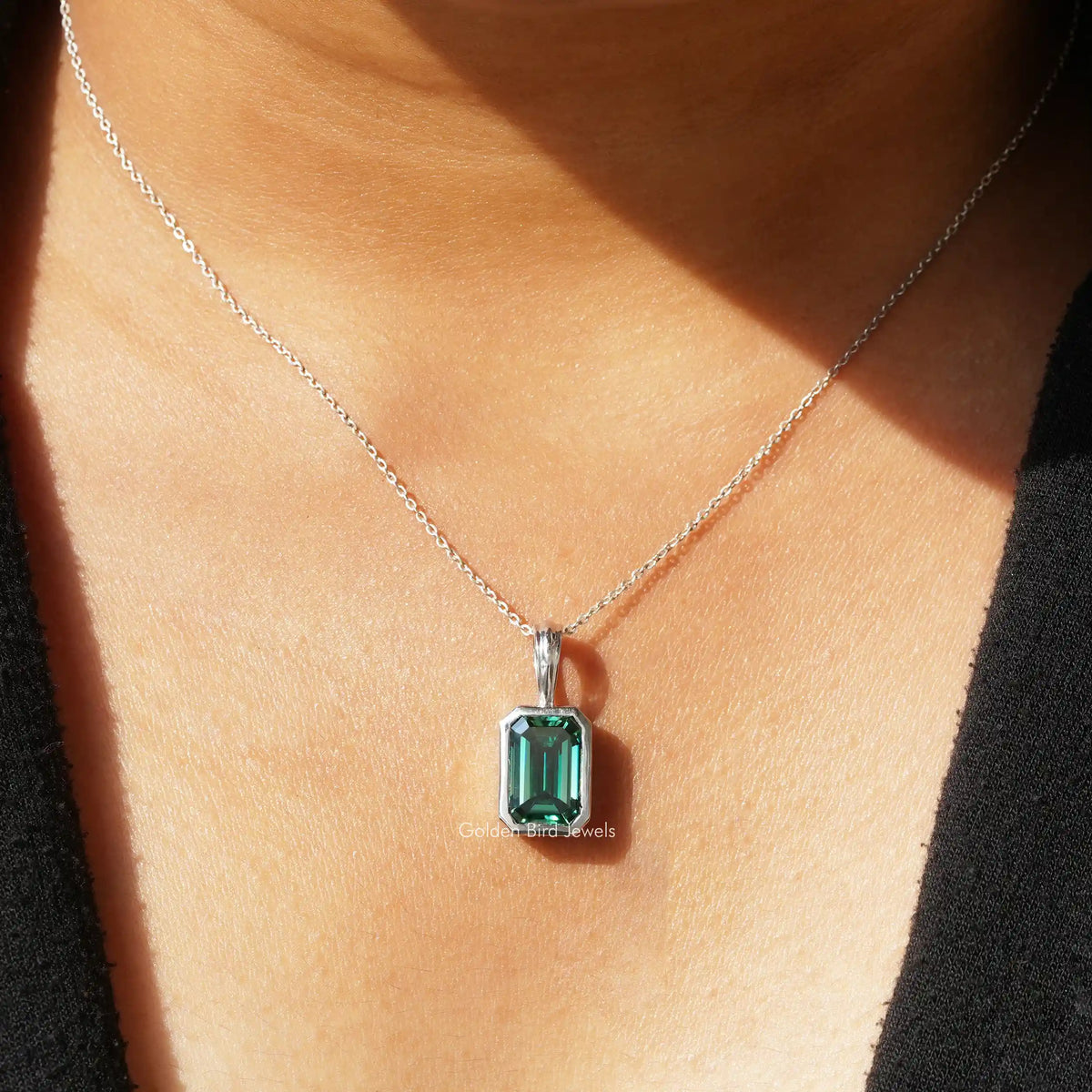 View of green emerald moissanite solitaire pendant 
