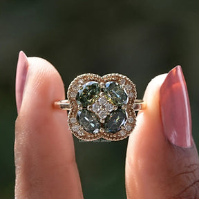 Two fingers holding the Oval Cut Halo Moissanite Engagement Ring