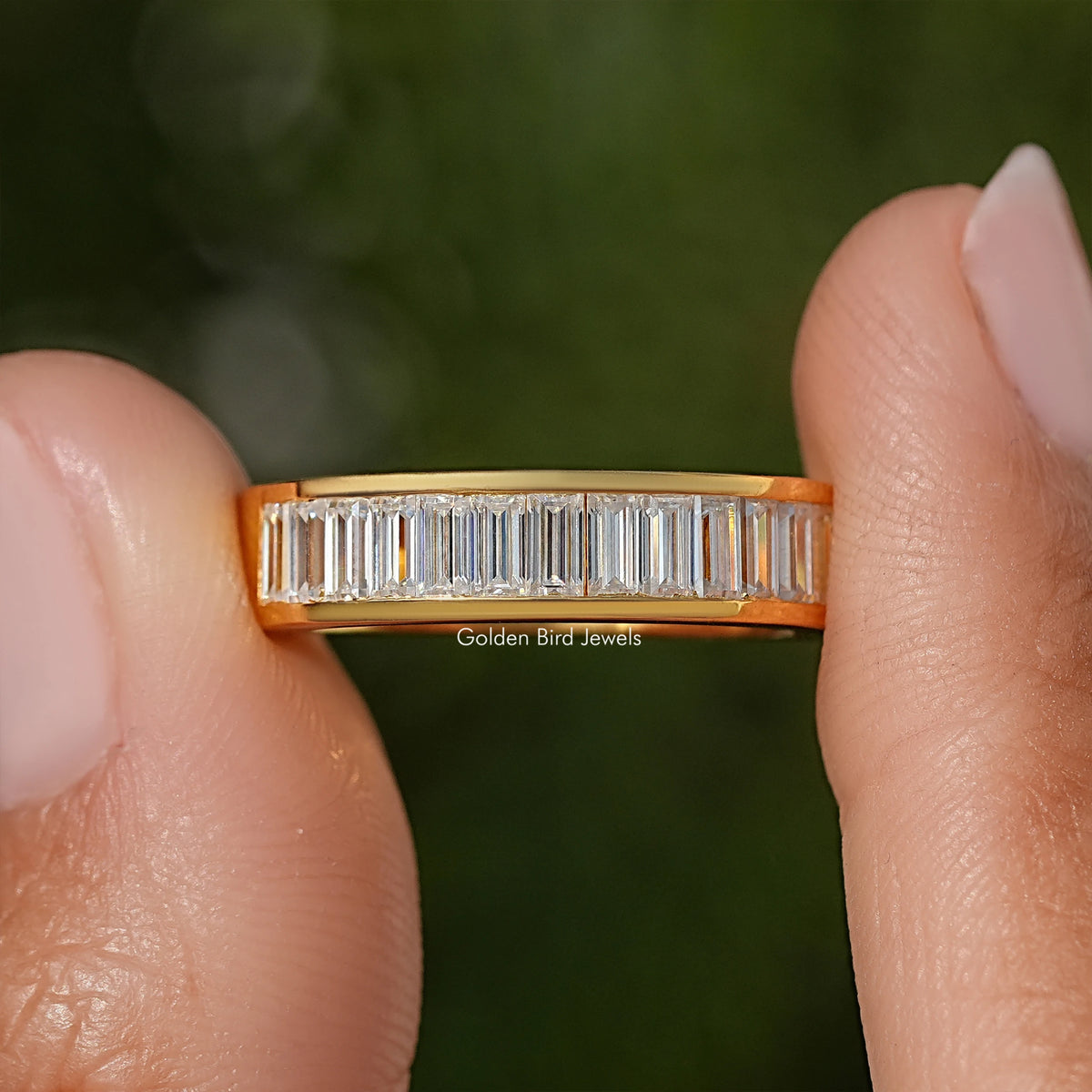 Yellow gold channel-set wedding band with baguette-cut moissanite stones