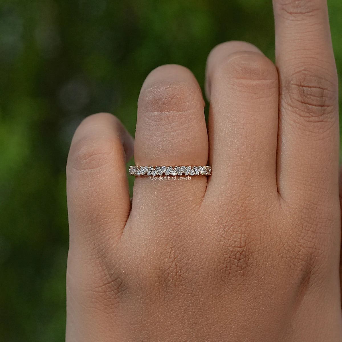 Gold-tone half eternity band with baguette lab diamonds, worn on finger