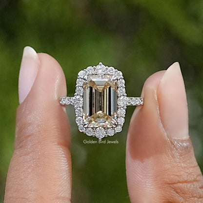 Sterling silver moissanite ring with emerald-cut center stone and sparkling halo