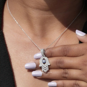 In hand showing view of moissanite pendant in white gold