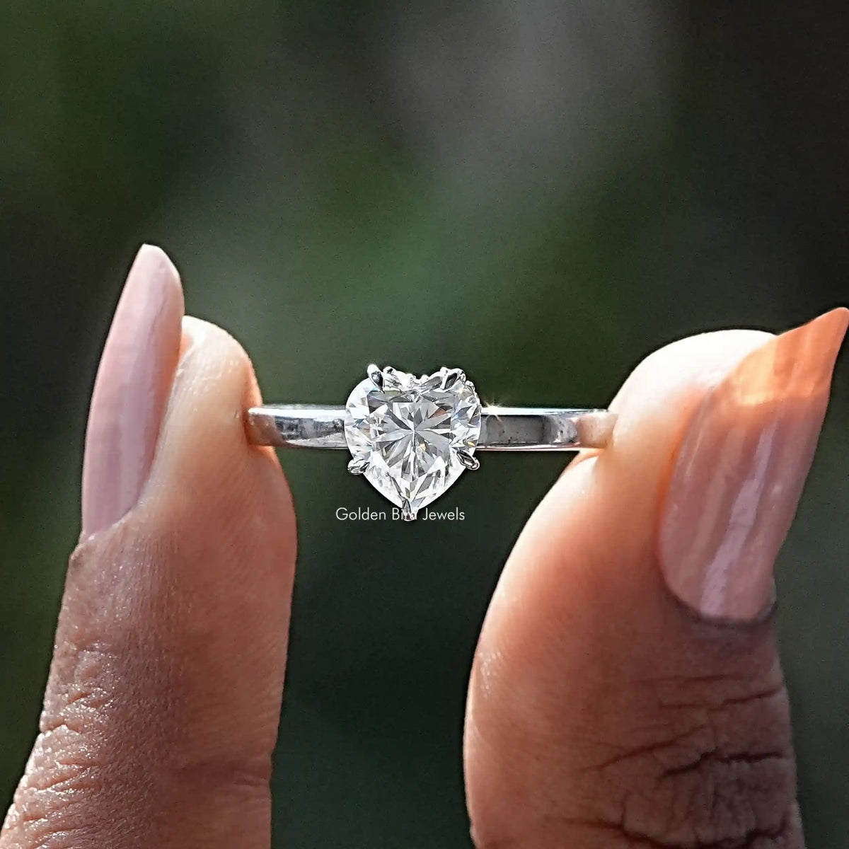 Front View of Heart Cut Hidden Halo Moissanite Ring In two Fingers