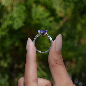 Back View of Kite Cut Gemstone Halo Accent Ring In two fingers