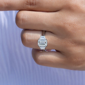View of Emerald Cut Diamond Three Stone Ring In Yellow Gold