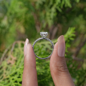 Back View of A Marquise And Round Cut Diamond Ring In two fingers