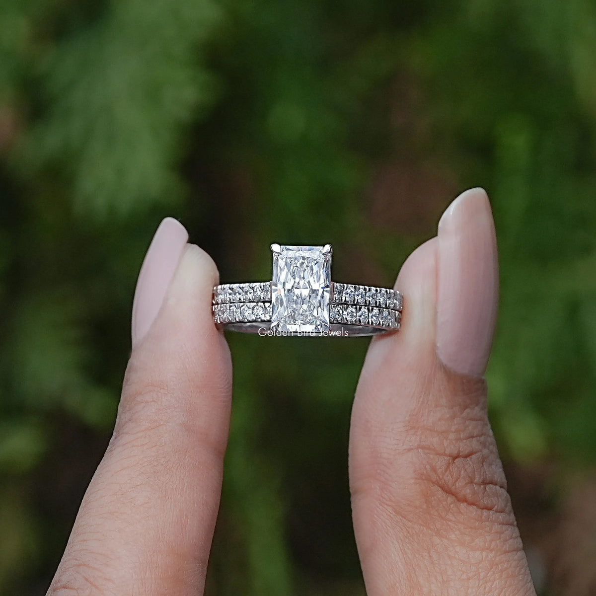 Front view of Lab Diamond Radiant Cut Bridal Ring holding in two fingers 