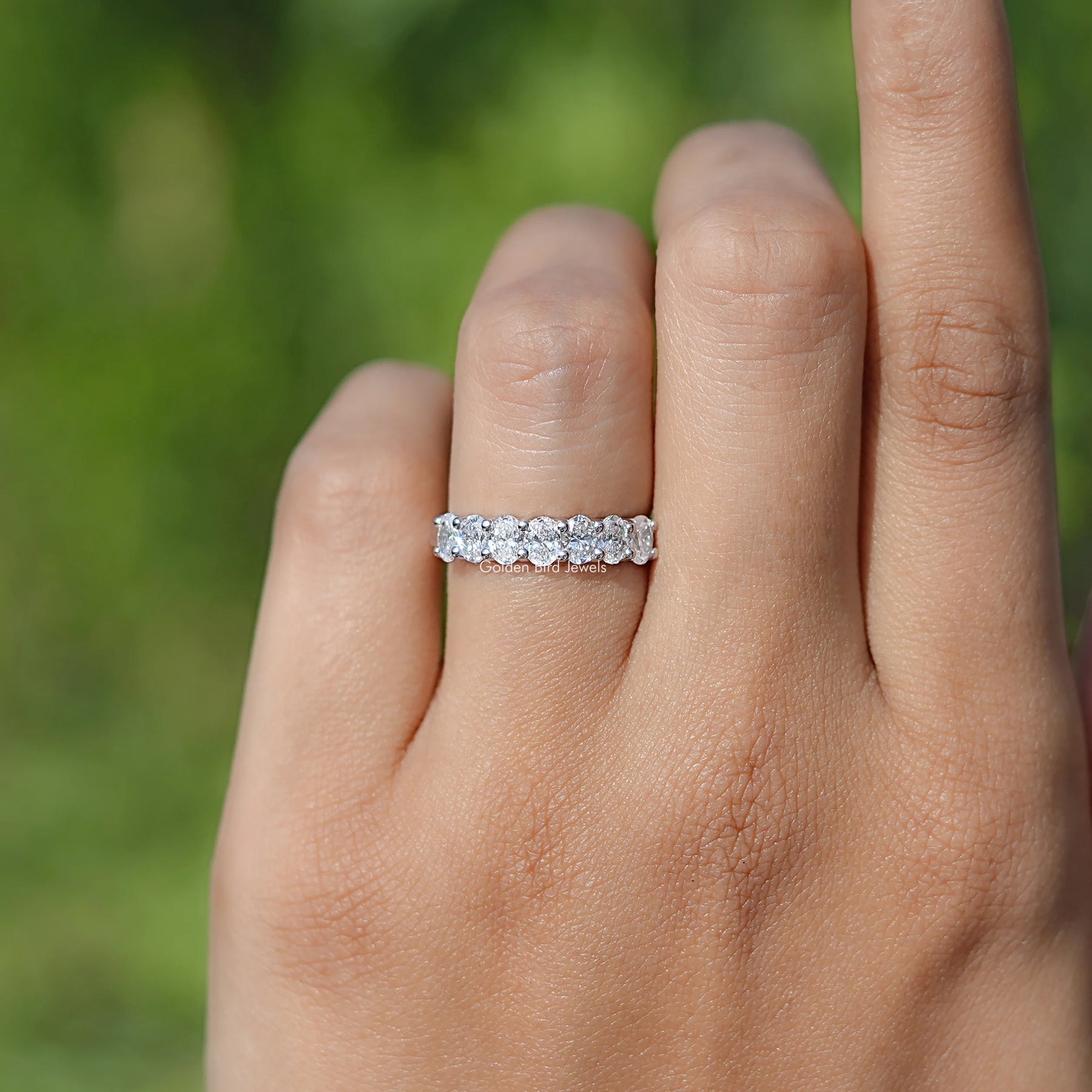 In finger front view of Lab Diamond Seven stone wedding band  